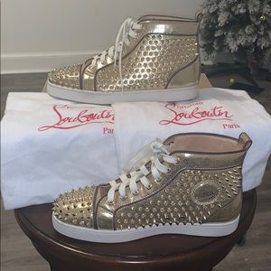 Gold Christian Louboutin spikes flat